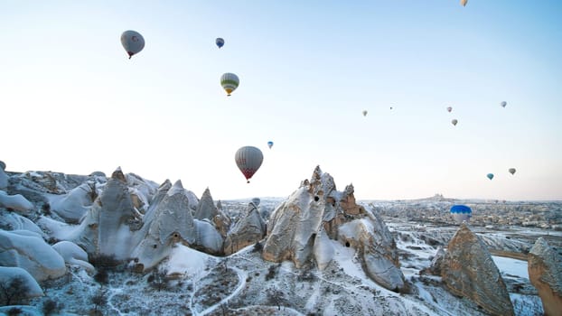 Colorful balloons over volcanic rocks in Cappadocia. Turkey