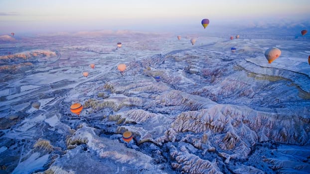 Colorful balloons over volcanic rocks in Cappadocia. Turkey