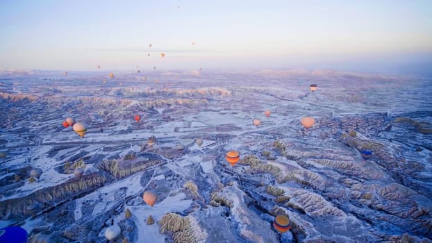 Colorful balloons over volcanic rocks in Cappadocia. Turkey