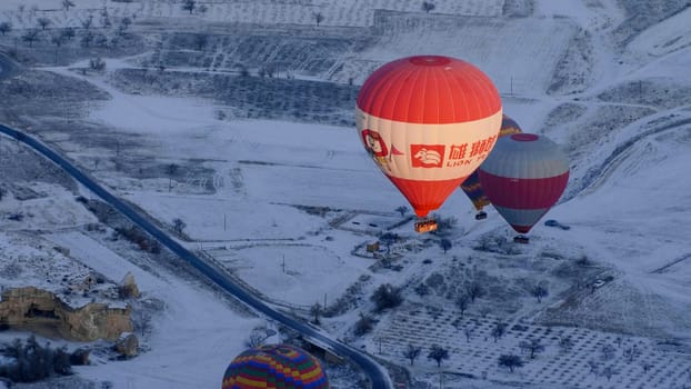 Colorful balloons over volcanic rocks in Cappadocia. Turkey