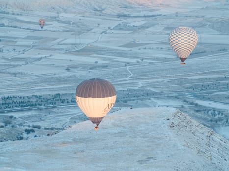 Colorful balloons over volcanic rocks in Cappadocia. Turkey