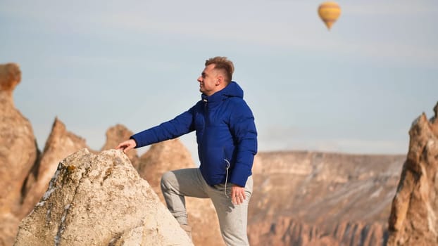 A young man ascended the rocks in Cappadocia