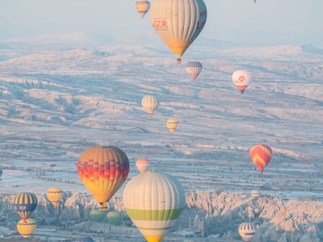 Colorful balloons over volcanic rocks in Cappadocia. Turkey
