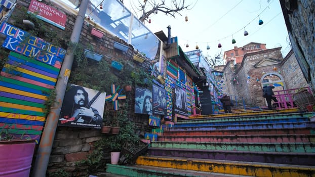 Stairs painted in various colors located in the historical district of Balat. Tourists and people are visiting this historical place.