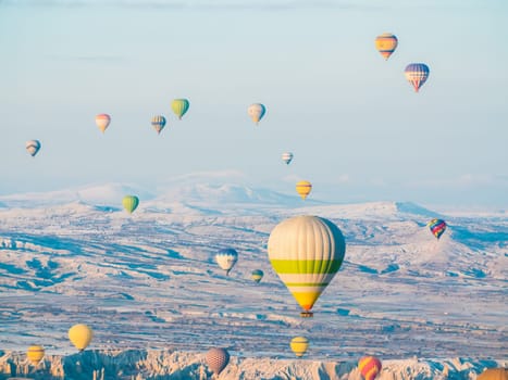 Colorful balloons over volcanic rocks in Cappadocia. Turkey