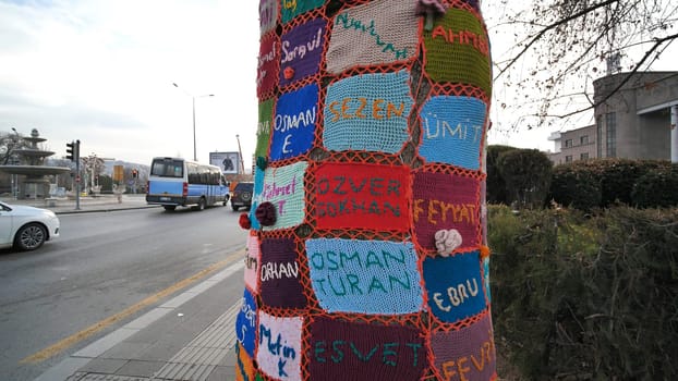 A tree trunk entwined with fabrics near the railway station of Ankara