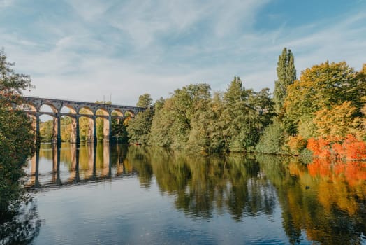 Railway Bridge with river in Bietigheim-Bissingen, Germany. Autumn. Railway viaduct over the Enz River, built in 1853 by Karl von Etzel on a sunny summer day. Bietigheim-Bissingen, Germany. Old viaduct in Bietigheim reflected in the river. Baden-Wurttemberg, Germany. Train passing a train bridge on a cloudy day in Germany