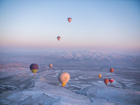 Colorful balloons over volcanic rocks in Cappadocia. Turkey