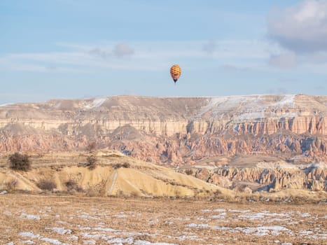 Colorful balloons over volcanic rocks in Cappadocia. Turkey