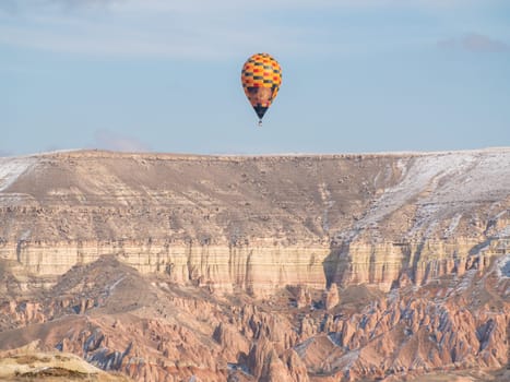 Colorful balloons over volcanic rocks in Cappadocia. Turkey