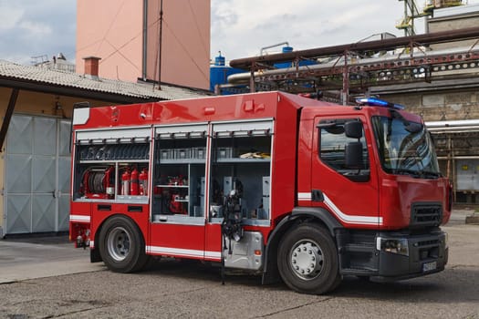 A state-of-the-art firetruck, equipped with advanced rescue technology, stands ready with its skilled firefighting team, prepared to intervene and respond rapidly to emergencies, ensuring the safety and protection of the community. High quality photo