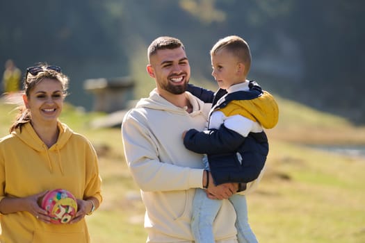 A modern family, along with their son, revels in the joy of a muddy day in nature, running and playing together, encapsulating the beauty of a healthy and active lifestyle.