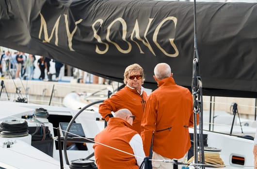 Monaco, Monte Carlo, 29 September 2022 - Invited wealthy clients inspect mega yachts at the largest fair exhibition in the world yacht show MYS, port Hercules, yacht brokers, sunny weather. High quality photo