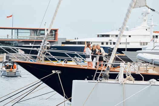 Monaco, Monte Carlo, 29 September 2022 - Invited wealthy clients inspect mega yachts at the largest fair exhibition in the world yacht show MYS, port Hercules, yacht brokers, sunny weather. High quality photo