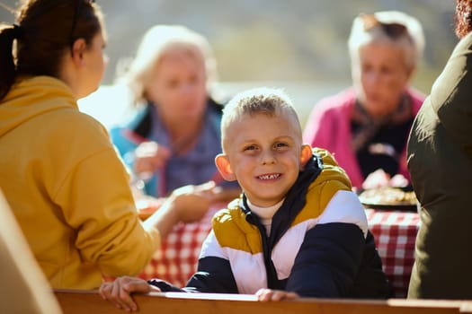 A family on a mountain vacation indulges in the pleasures of a healthy life, savoring traditional pie while surrounded by the breathtaking beauty of nature, fostering family bonds and embracing the vitality of their mountain retreat.