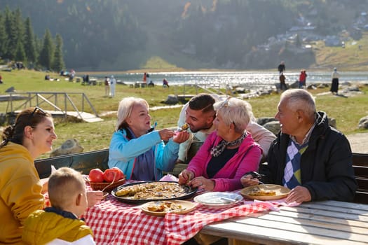 A family on a mountain vacation indulges in the pleasures of a healthy life, savoring traditional pie while surrounded by the breathtaking beauty of nature, fostering family bonds and embracing the vitality of their mountain retreat.