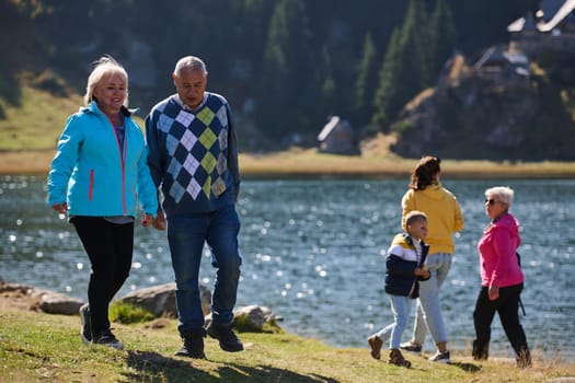 A family shares delightful moments with their friends amid the stunning landscapes of mountains, lakes, and winding paths, promoting a healthy lifestyle and the joy of familial bonds in the embrace of nature's beauty.