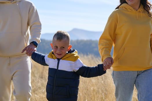 A modern family, along with their son, revels in the joy of a muddy day in nature, running and playing together, encapsulating the beauty of a healthy and active lifestyle.