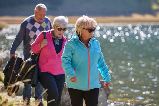 A family shares delightful moments with their friends amid the stunning landscapes of mountains, lakes, and winding paths, promoting a healthy lifestyle and the joy of familial bonds in the embrace of nature's beauty.