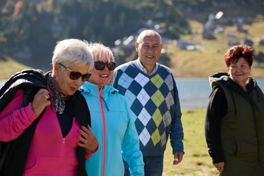 A family shares delightful moments with their friends amid the stunning landscapes of mountains, lakes, and winding paths, promoting a healthy lifestyle and the joy of familial bonds in the embrace of nature's beauty.