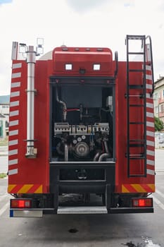 A state-of-the-art firetruck, equipped with advanced rescue technology, stands ready with its skilled firefighting team, prepared to intervene and respond rapidly to emergencies, ensuring the safety and protection of the community. High quality photo