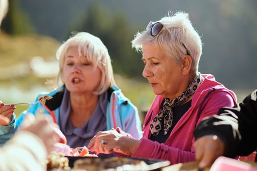 A family on a mountain vacation indulges in the pleasures of a healthy life, savoring traditional pie while surrounded by the breathtaking beauty of nature, fostering family bonds and embracing the vitality of their mountain retreat.