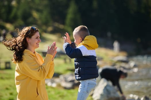 A mother and son create cherished memories as they playfully engage in outdoor activities, their laughter echoing the joy of shared moments and the bond between parent and child.