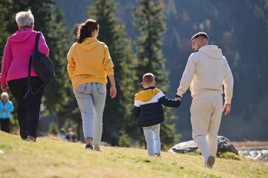 A family shares delightful moments with their friends amid the stunning landscapes of mountains, lakes, and winding paths, promoting a healthy lifestyle and the joy of familial bonds in the embrace of nature's beauty.