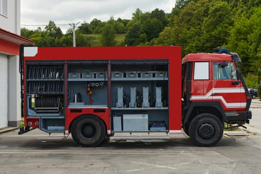 A state-of-the-art firetruck, equipped with advanced rescue technology, stands ready with its skilled firefighting team, prepared to intervene and respond rapidly to emergencies, ensuring the safety and protection of the community. High quality photo