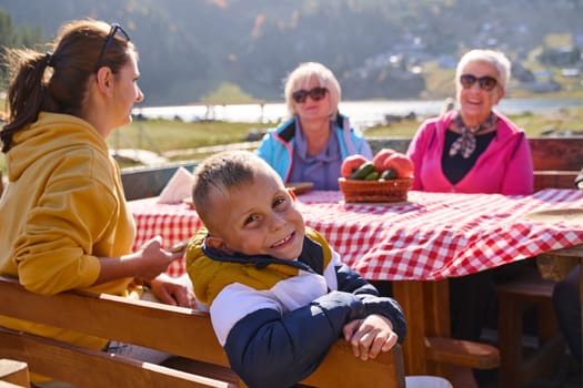 A family on a mountain vacation indulges in the pleasures of a healthy life, savoring traditional pie while surrounded by the breathtaking beauty of nature, fostering family bonds and embracing the vitality of their mountain retreat.