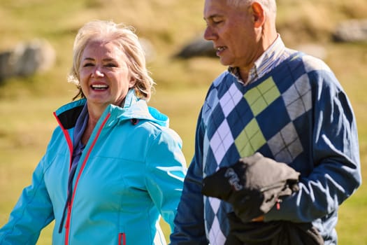 Elderly couple strolling through the breathtaking beauty of nature, maintaining their vitality and serenity, embracing the joys of a health-conscious and harmonious lifestyle.