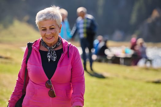 A senior woman finds serenity and wellness as she strolls through nature, illustrating the beauty of maintaining an active and health-conscious lifestyle in her golden years.