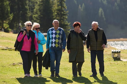 A family shares delightful moments with their friends amid the stunning landscapes of mountains, lakes, and winding paths, promoting a healthy lifestyle and the joy of familial bonds in the embrace of nature's beauty.