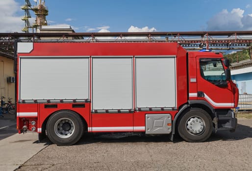 A state-of-the-art firetruck, equipped with advanced rescue technology, stands ready with its skilled firefighting team, prepared to intervene and respond rapidly to emergencies, ensuring the safety and protection of the community. High quality photo