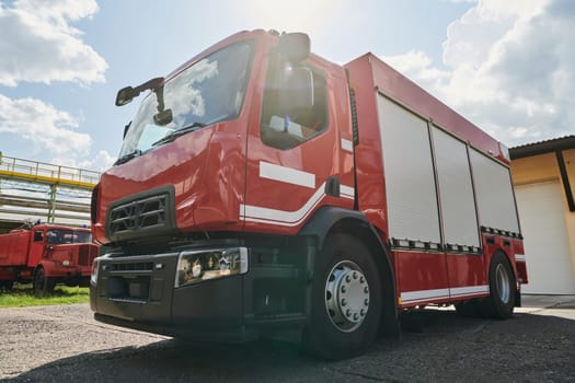 A state-of-the-art firetruck, equipped with advanced rescue technology, stands ready with its skilled firefighting team, prepared to intervene and respond rapidly to emergencies, ensuring the safety and protection of the community. High quality photo