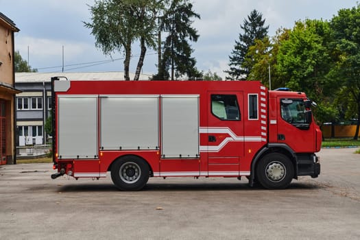 A state-of-the-art firetruck, equipped with advanced rescue technology, stands ready with its skilled firefighting team, prepared to intervene and respond rapidly to emergencies, ensuring the safety and protection of the community. High quality photo