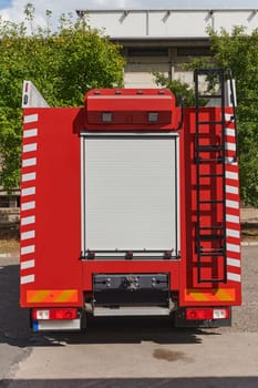 A state-of-the-art firetruck, equipped with advanced rescue technology, stands ready with its skilled firefighting team, prepared to intervene and respond rapidly to emergencies, ensuring the safety and protection of the community. High quality photo