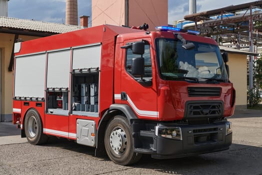 A state-of-the-art firetruck, equipped with advanced rescue technology, stands ready with its skilled firefighting team, prepared to intervene and respond rapidly to emergencies, ensuring the safety and protection of the community. High quality photo