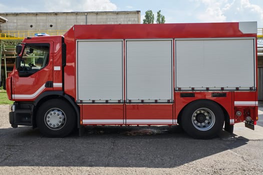 A state-of-the-art firetruck, equipped with advanced rescue technology, stands ready with its skilled firefighting team, prepared to intervene and respond rapidly to emergencies, ensuring the safety and protection of the community. High quality photo