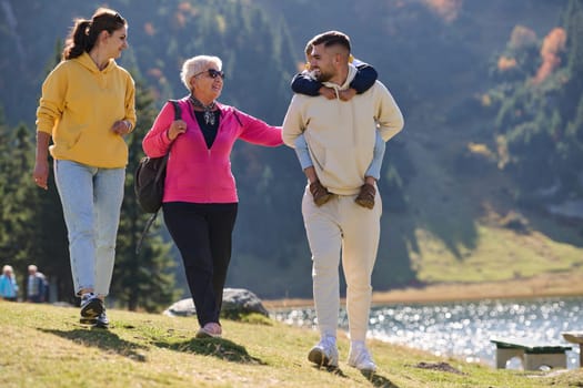 A family shares delightful moments with their friends amid the stunning landscapes of mountains, lakes, and winding paths, promoting a healthy lifestyle and the joy of familial bonds in the embrace of nature's beauty.