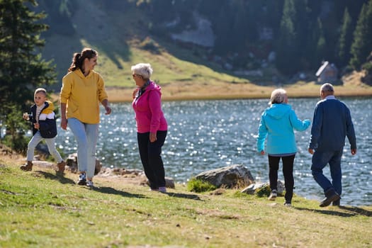 A family shares delightful moments with their friends amid the stunning landscapes of mountains, lakes, and winding paths, promoting a healthy lifestyle and the joy of familial bonds in the embrace of nature's beauty.