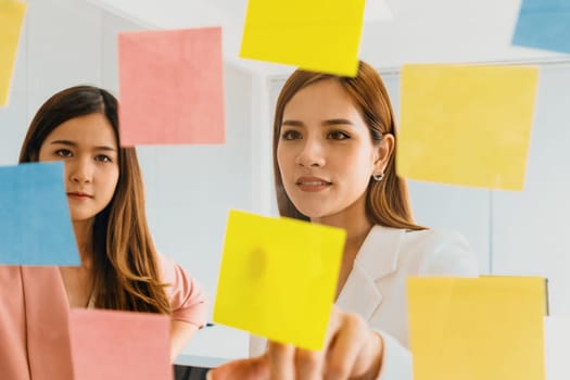 Creative Asian businesswoman in meeting workshop coming up with many positive ideas to help developing their corporate business. Group discussing and brainstorm concept. uds