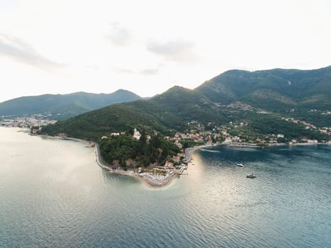 Cape of the town of Lepetane at the foot of the mountains on the seashore. Montenegro. High quality photo