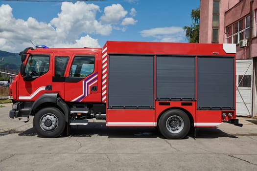 A state-of-the-art firetruck, equipped with advanced rescue technology, stands ready with its skilled firefighting team, prepared to intervene and respond rapidly to emergencies, ensuring the safety and protection of the community. High quality photo