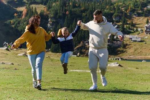 A modern family, along with their son, revels in the joy of a muddy day in nature, running and playing together, encapsulating the beauty of a healthy and active lifestyle.