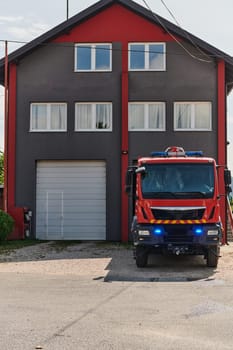 A state-of-the-art firetruck, equipped with advanced rescue technology, stands ready with its skilled firefighting team, prepared to intervene and respond rapidly to emergencies, ensuring the safety and protection of the community. High quality photo