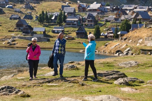 A family shares delightful moments with their friends amid the stunning landscapes of mountains, lakes, and winding paths, promoting a healthy lifestyle and the joy of familial bonds in the embrace of nature's beauty.