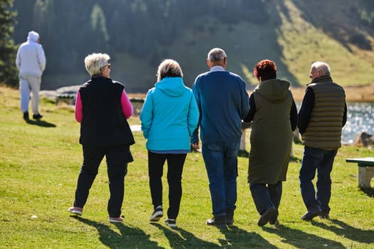 A family shares delightful moments with their friends amid the stunning landscapes of mountains, lakes, and winding paths, promoting a healthy lifestyle and the joy of familial bonds in the embrace of nature's beauty.