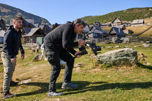 A skilled videographer, equipped with professional gear, captures the essence of nature's beauty, expertly documenting the scenic landscape in a cinematic masterpiece that reflects the seamless blend of technology and the wilderness