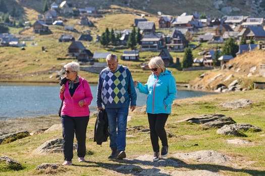 A family shares delightful moments with their friends amid the stunning landscapes of mountains, lakes, and winding paths, promoting a healthy lifestyle and the joy of familial bonds in the embrace of nature's beauty.